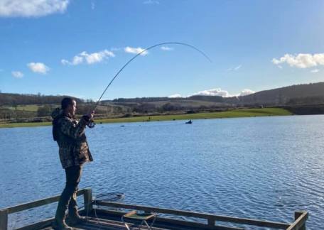 Dean Hedley netting one of his 8 fish on Saturday using Dries and Diawl Bach's