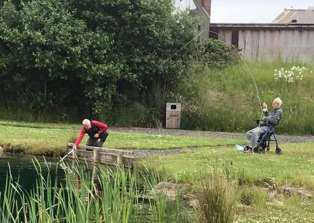 93 year old, Tommy Robinson landing his first fish of the day