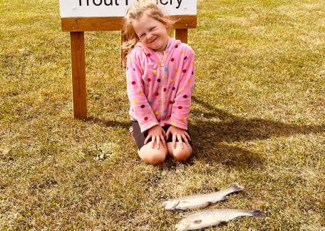 Izzy was delighted to land two fish from the Bait Lake with her Dad