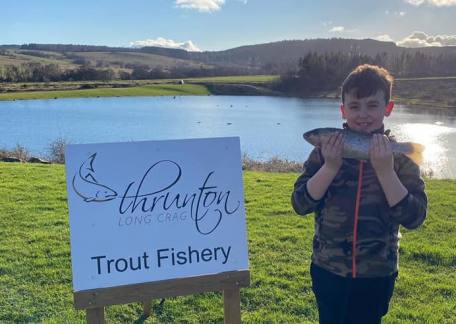 young Max with his dinner caught on Crag End Bait Lake