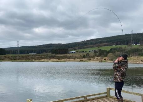 Drennan playing a 4lb Brown on Long Crag Lake 