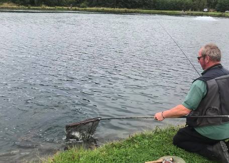 Tommy Mark netting one of his fish 