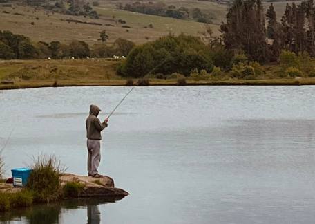 Ross Calder playing a fish on Coe Crag Lake