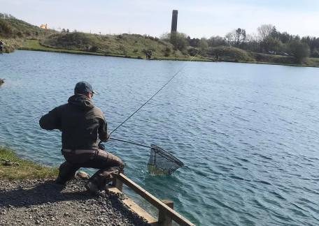 Phil Green netting one of his four fish during the AM session